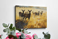 Framed canvas print of a deer herd in a golden autumn landscape with splattered paint effect.