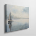 Framed canvas print of a serene sailboat with reflection on tranquil blue water
