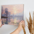 Impressionist-style painting of a peaceful river landscape at sunrise with reflections and tall trees.