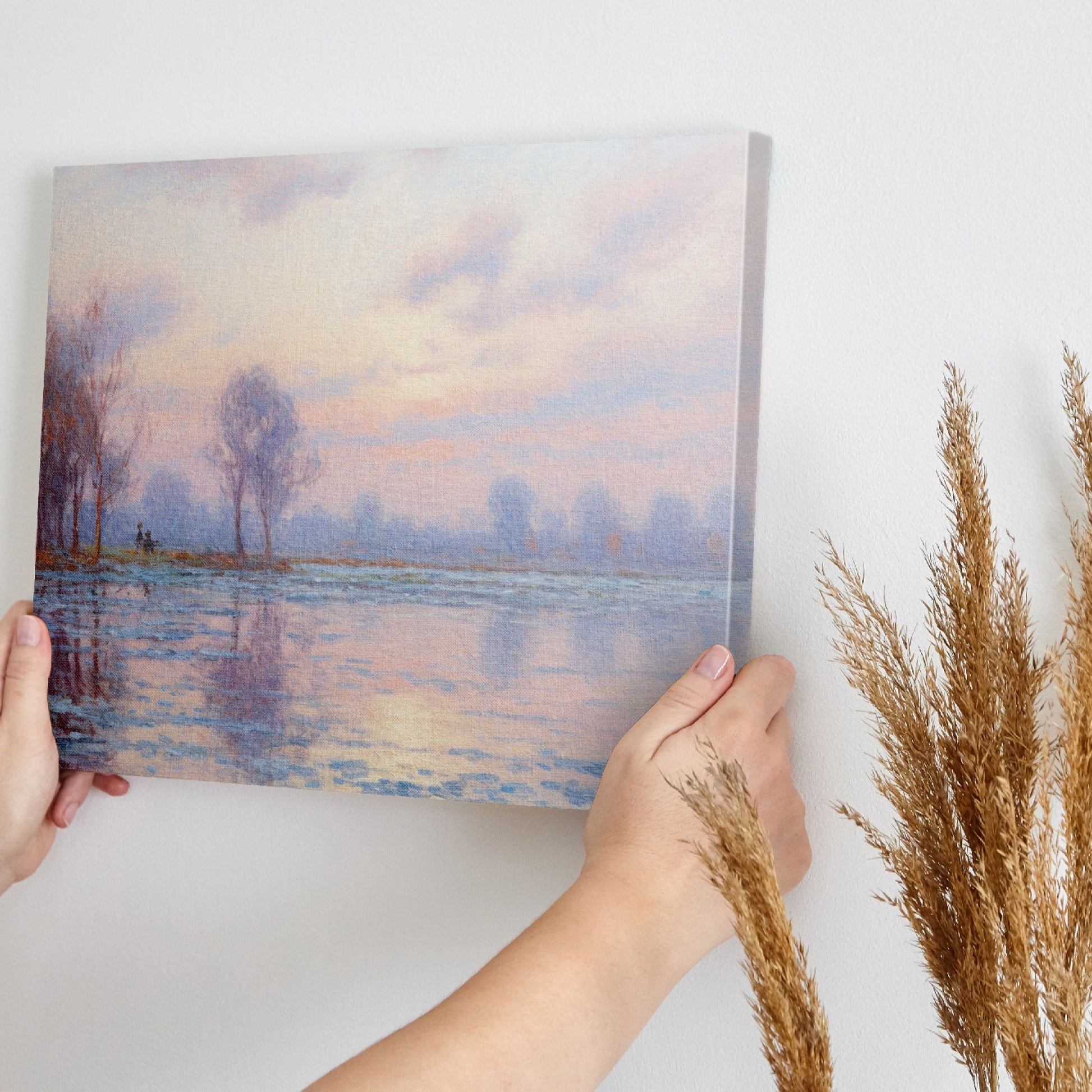 Pastel-hued landscape painting of a sunrise with reflections in the water and silhouetted trees.