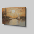Canvas print of a sunset with orange skies, sailboat on calm lake, and tree silhouettes