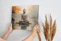 Framed canvas print of serene Buddha in meditative pose with abstract orange and blue background
