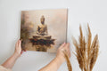 Framed canvas print of a serene Buddha in meditation with warm colour tones
