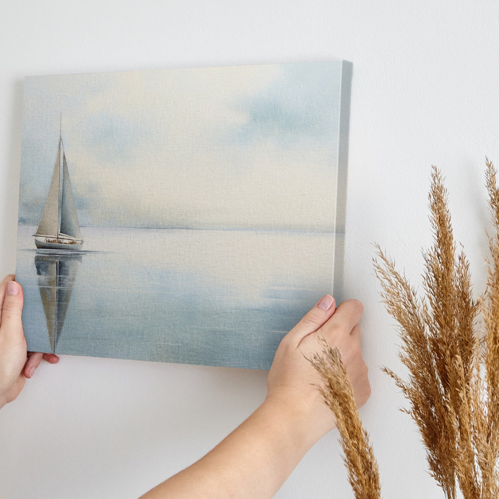 Framed canvas print of a serene sailboat with reflection on tranquil blue water