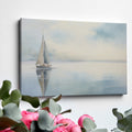 Framed canvas print of a serene sailboat with reflection on tranquil blue water