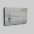 Framed canvas print of a serene sailboat with reflection on tranquil blue water