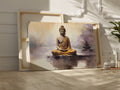 Framed canvas print of a meditative Buddha figure in golden and beige tones with a serene abstract background