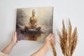 Canvas print of a meditating Buddha in warm amber and brown tones on a textured abstract background