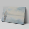 Framed canvas print of a serene sailboat with reflection on tranquil blue water