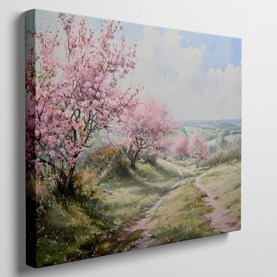 Canvas print of a countryside path with pink cherry blossoms and green fields under a blue sky with clouds.