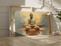 Framed canvas print of serene Buddha in meditation with abstract warm golden background