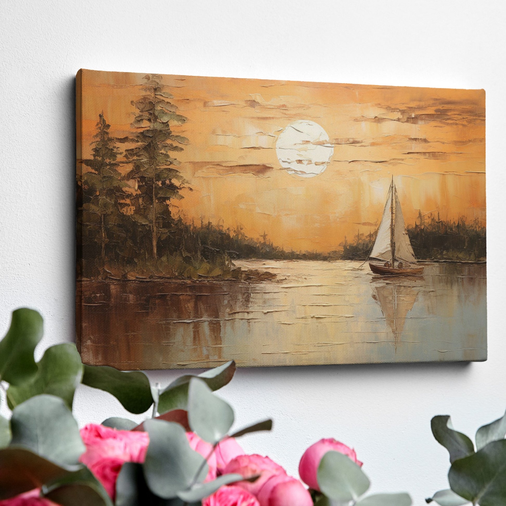Canvas print of a sunset with orange skies, sailboat on calm lake, and tree silhouettes