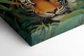 Canvas print of a tiger in a jungle with vivid green leaves around it