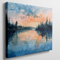 Framed canvas print of a watercolour painting with sunset over a lake and forest silhouette