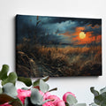 Framed canvas print of a dramatic sunset over a rustic meadow with vivid warm tones