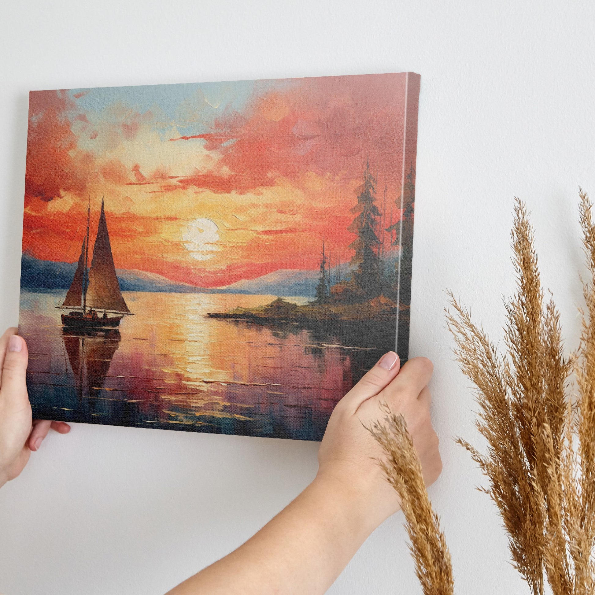 Framed canvas print of a sailboat sailing at sunset with vibrant sky and reflective water