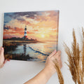 Framed canvas print of an impressionist lighthouse by the sea at sunset with vibrant colours