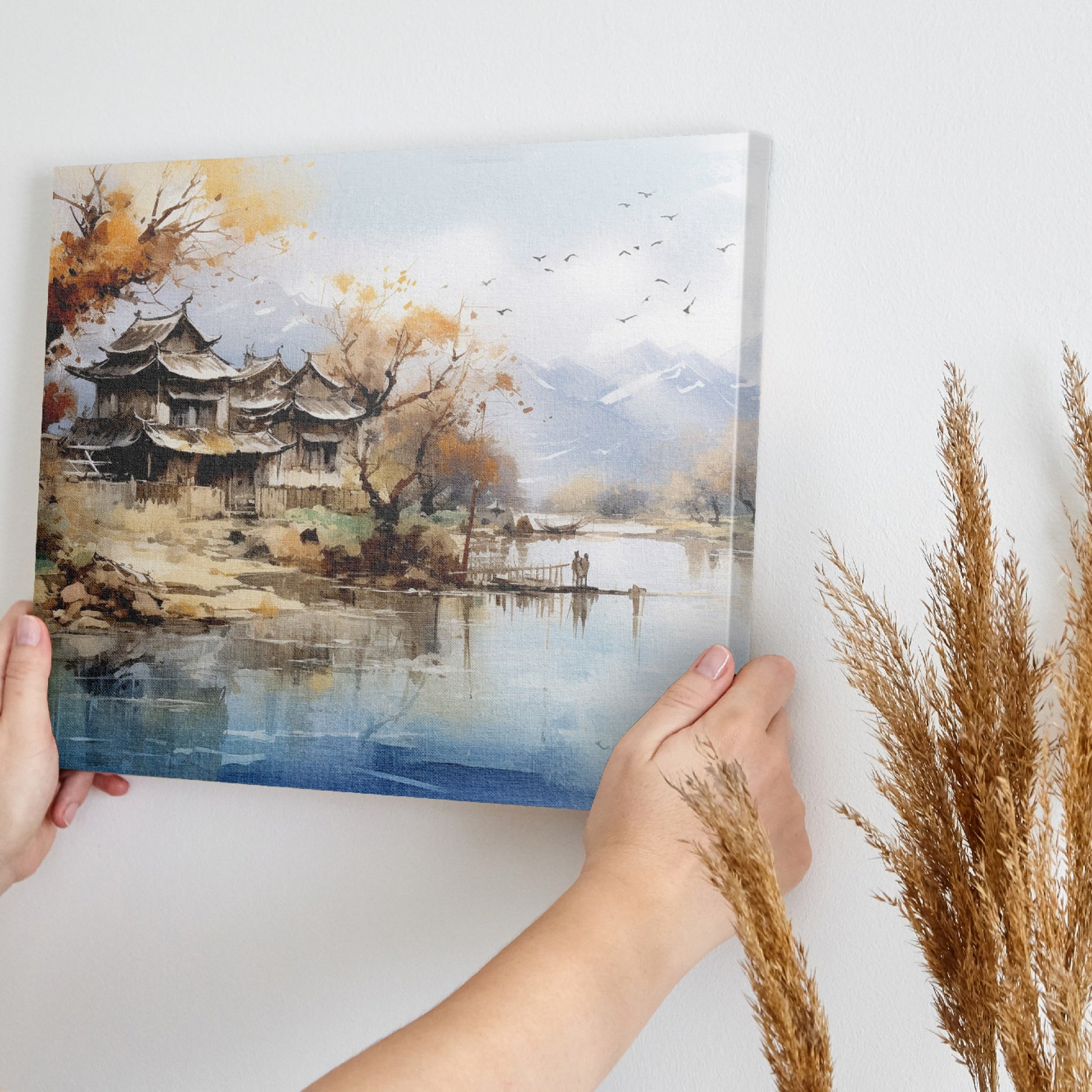 Canvas art of a tranquil oriental landscape with autumnal trees, traditional architecture, calm water, and mountains in the background.