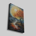 Framed canvas print of an autumnal tree with orange and red leaves against a sunset over a blue seascape