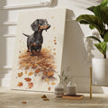 Framed canvas print of a realistic Dachshund standing amidst autumn leaves in warm brown and amber tones