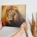 Framed canvas print of a majestic lion portrait with a warm golden colour scheme