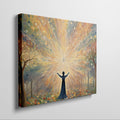 Framed canvas print of a figure silhouetted against a radiant background with mystical trees and glowing orbs.