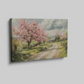 Framed canvas print of a picturesque countryside with cherry blossoms and a farmhouse