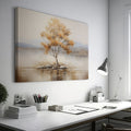 Framed canvas print of a solitary tree with autumn leaves reflected on a calm lake with warm beige, gold, and white tones