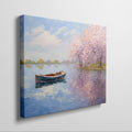 Framed canvas print of an impressionist painting featuring cherry blossoms and a serene lake with a boat