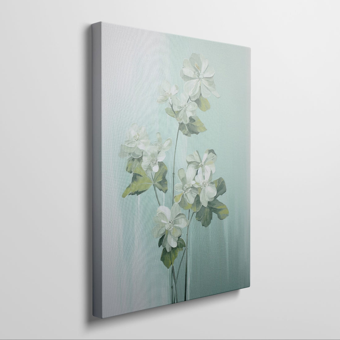 Framed canvas print of white blossoms with green leaves on a soft blue background