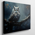 Framed canvas print of a mystical owl with amber eyes perched on a branch against a dark, moody background with autumn leaves