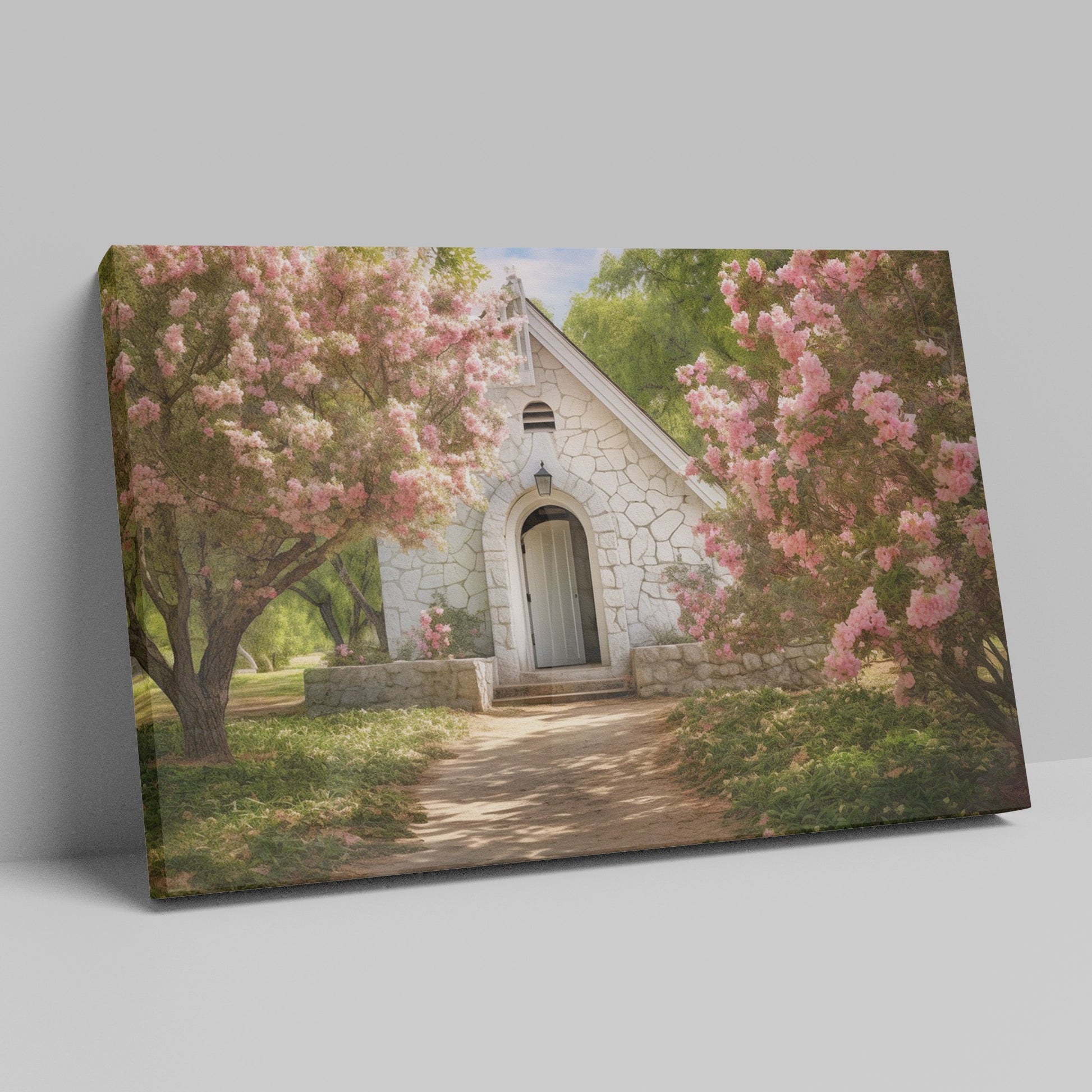 Framed canvas print of a chapel surrounded by lush pink blossom trees