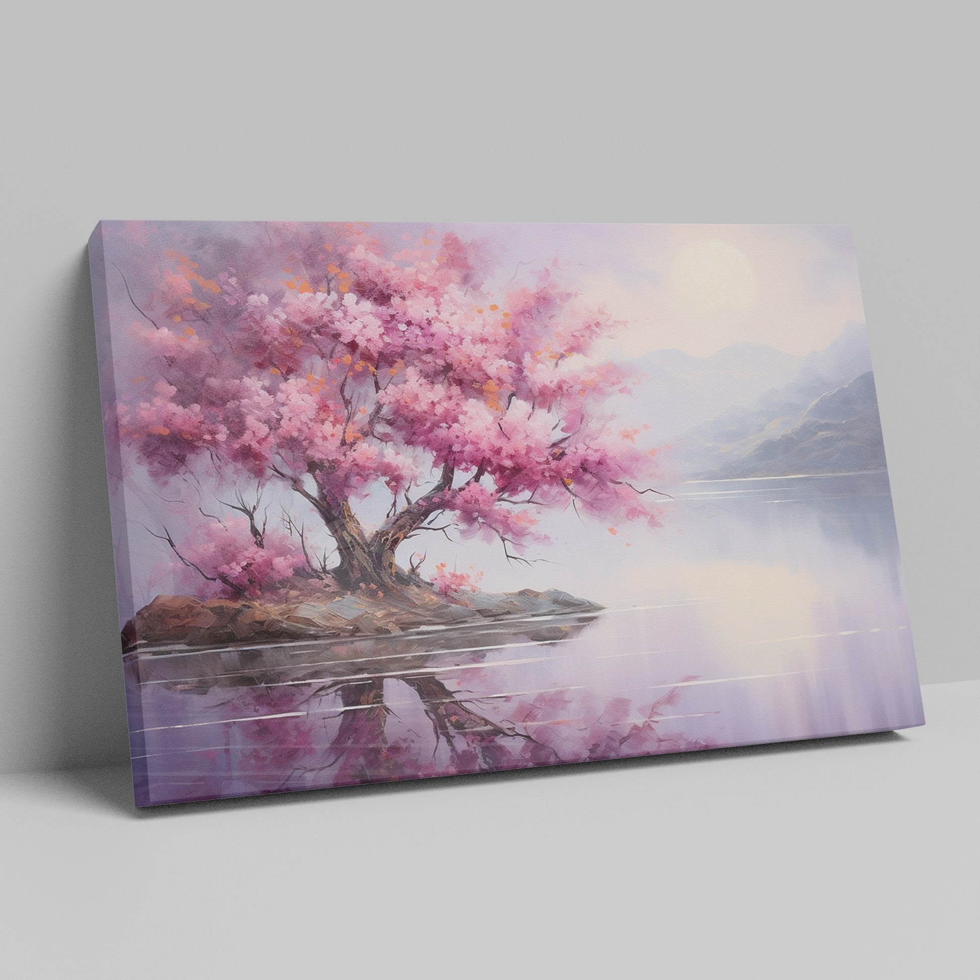 Framed canvas print of a cherry blossom tree by a tranquil lake at dusk with mountains in the background, reflecting soft pink and purple hues