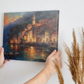 Framed canvas print of a watercolour Mediterranean village at twilight with reflections on the sea