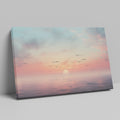 Framed canvas print of a tranquil seascape at sunset with birds and pastel skies