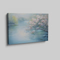 Framed canvas print of serene riverscape with cherry blossoms in impressionist style