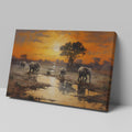 Framed canvas print of African elephants walking beside water during a vibrant sunset