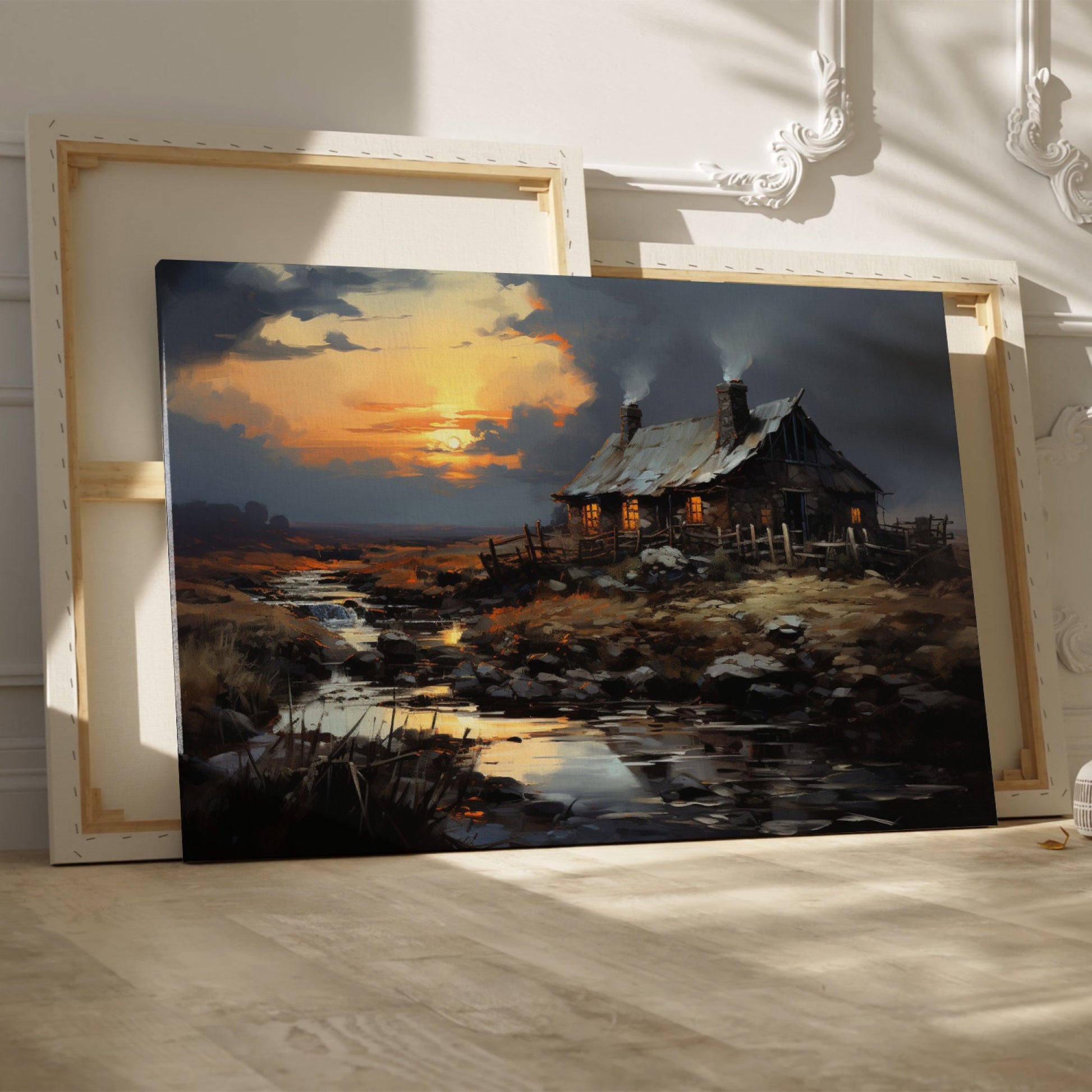 Framed canvas print of a rustic cottage with illuminated windows at sunset, set against a serene countryside landscape with a reflective creek.