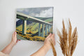 Framed canvas print of a modern landscape with a bridge over rural countryside