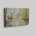 Framed canvas print of a deer standing beside a forest stream in impressionist style