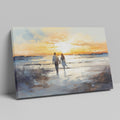 Framed canvas print of a couple walking on the beach at sunset with reflective water and warm colours