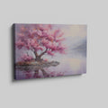 Framed canvas print of a cherry blossom tree by a tranquil lake at dusk with mountains in the background, reflecting soft pink and purple hues