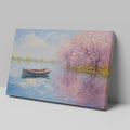 Framed canvas print of an impressionist painting featuring cherry blossoms and a serene lake with a boat