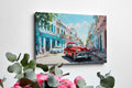 Framed canvas print of a vibrant Cuban street with vintage cars and colourful buildings