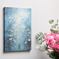 Framed canvas print of ethereal blue abstract painting with white flowers and a woman's silhouette