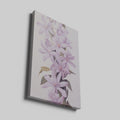 Framed canvas print of delicate lilac blossoms with pastel purple petals and green leaves