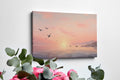 Framed canvas print of a serene seascape at sunset with flying birds and calm ocean waters