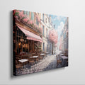 Framed canvas print of a picturesque Parisian alley with cherry blossoms and a street cafe scene in springtime