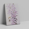 Framed canvas print of delicate lilac blossoms with pastel purple petals and green leaves