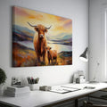 Framed canvas print of Highland cattle in a scenic landscape at sunset with warm hues